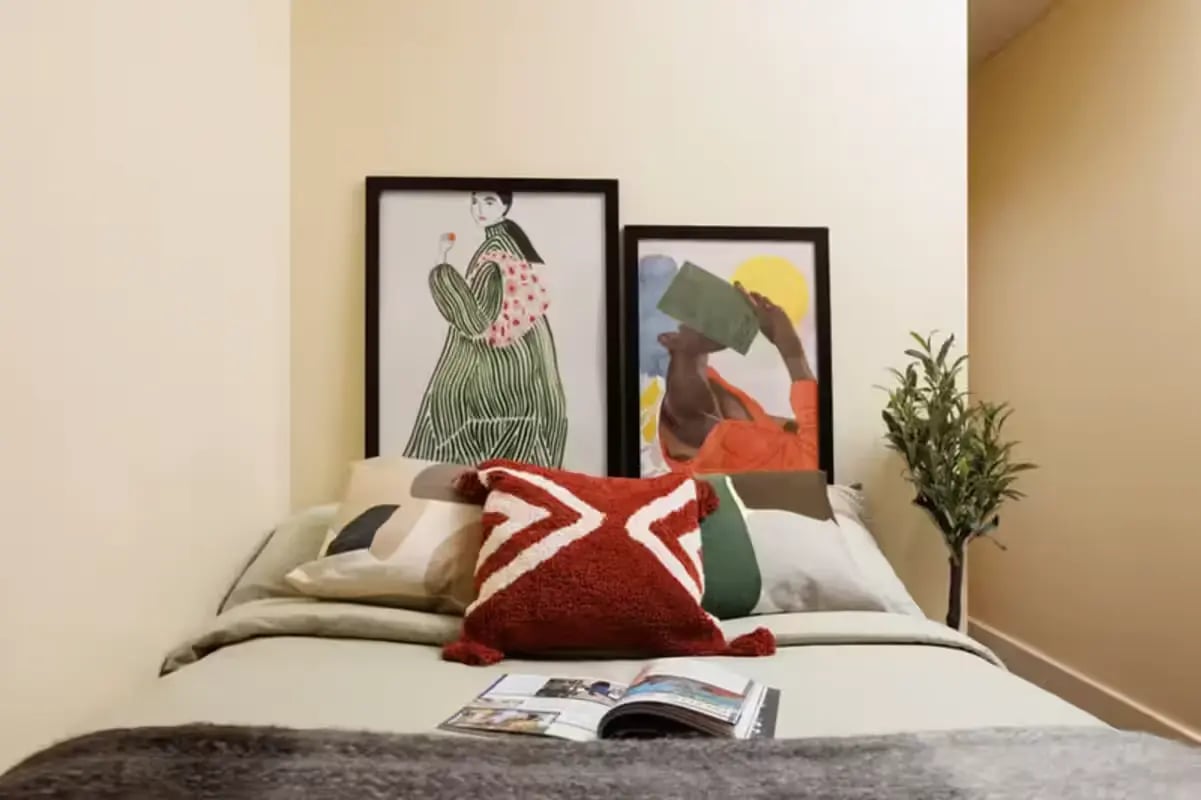 Bed with art and pillows bedroom at Curzon House in Nottingham Student Accommodation