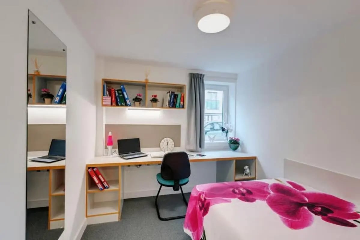 Desk with laptops and bed bedroom at The Old Dairy in Plymouth Student Accommodation