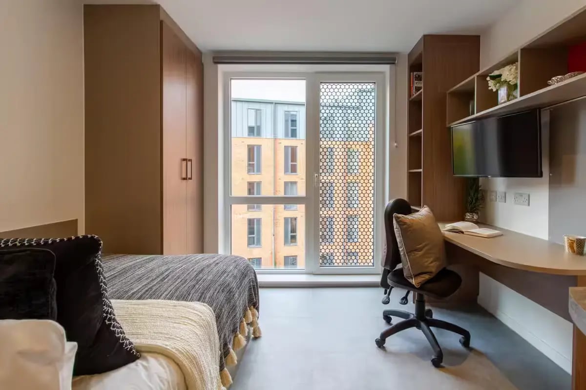 Bed wardrobe desk chair and television bedroom at Dean Street Works in Bristol Student Accommodation