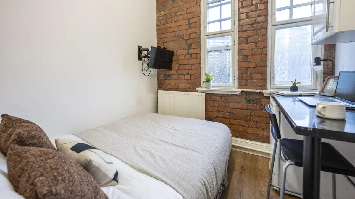 Bed laptop desk and TV bedroom at Ashton House in Manchester Student Accommodation