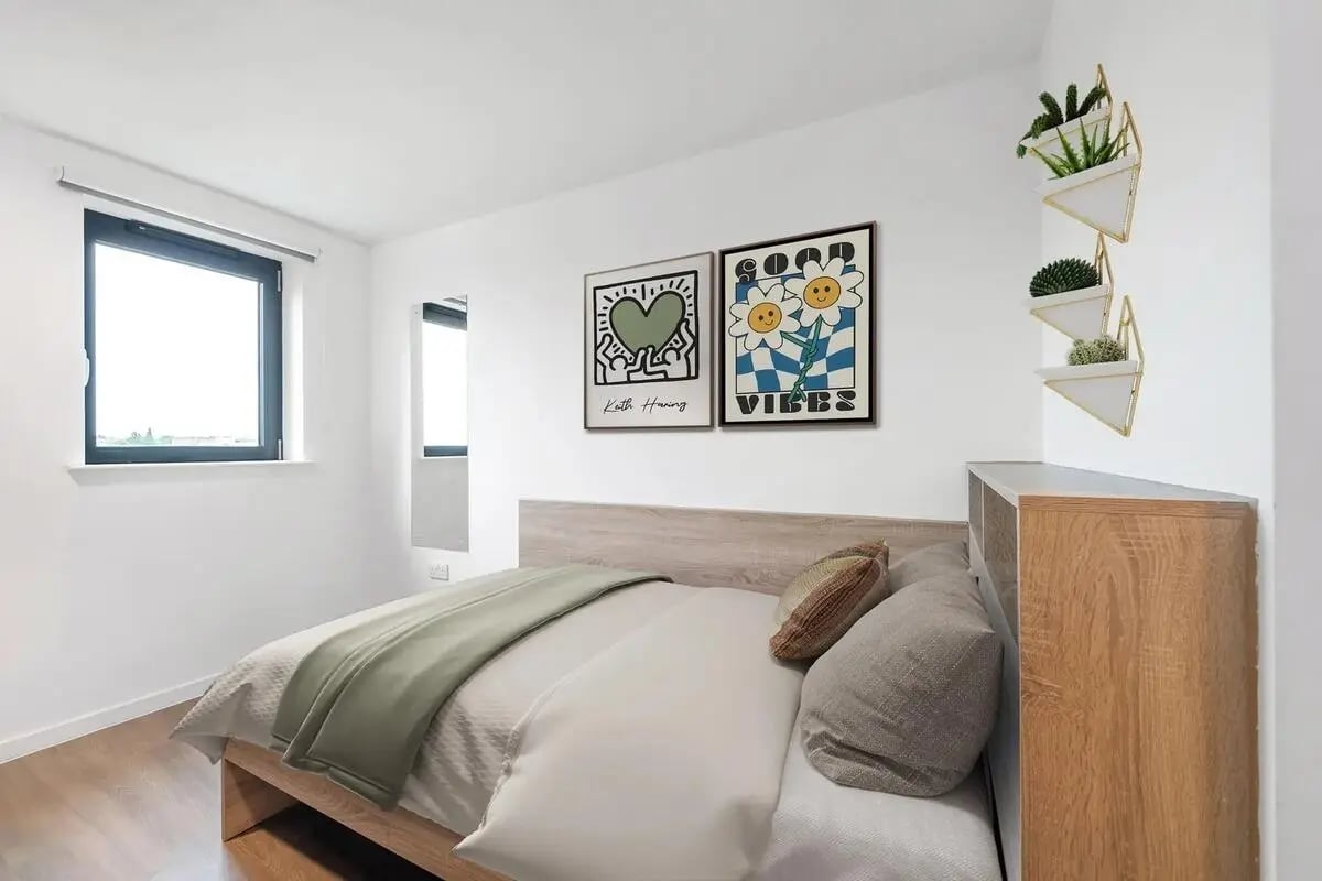 Bed with posters and plants bedroom at Wembley Barnard Point in London Student Accommodation
