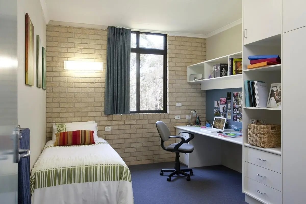 Bed desk chair and shelving unit bedroom study area at UniLodge SCU Coffs Harbour in Coffs Harbour Student Accommodation