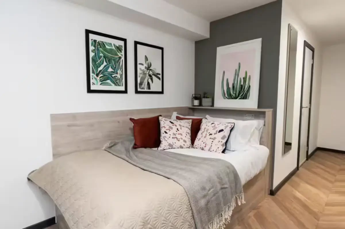 Bed with decorative pillows and art bedroom at Steelworks in Sheffield Student Accommodation