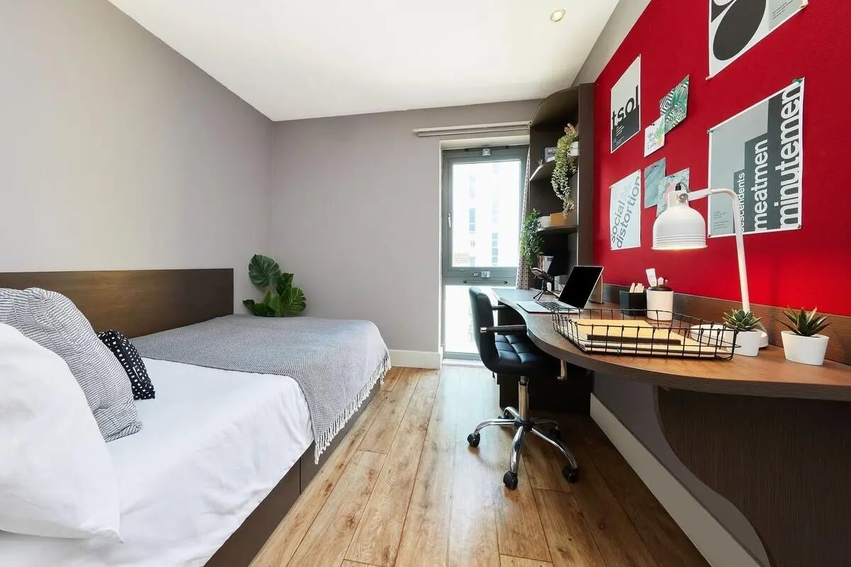 Bed desk chair laptop plants bedroom study area at Collegiate Dashwood Studios in London Student Accommodation