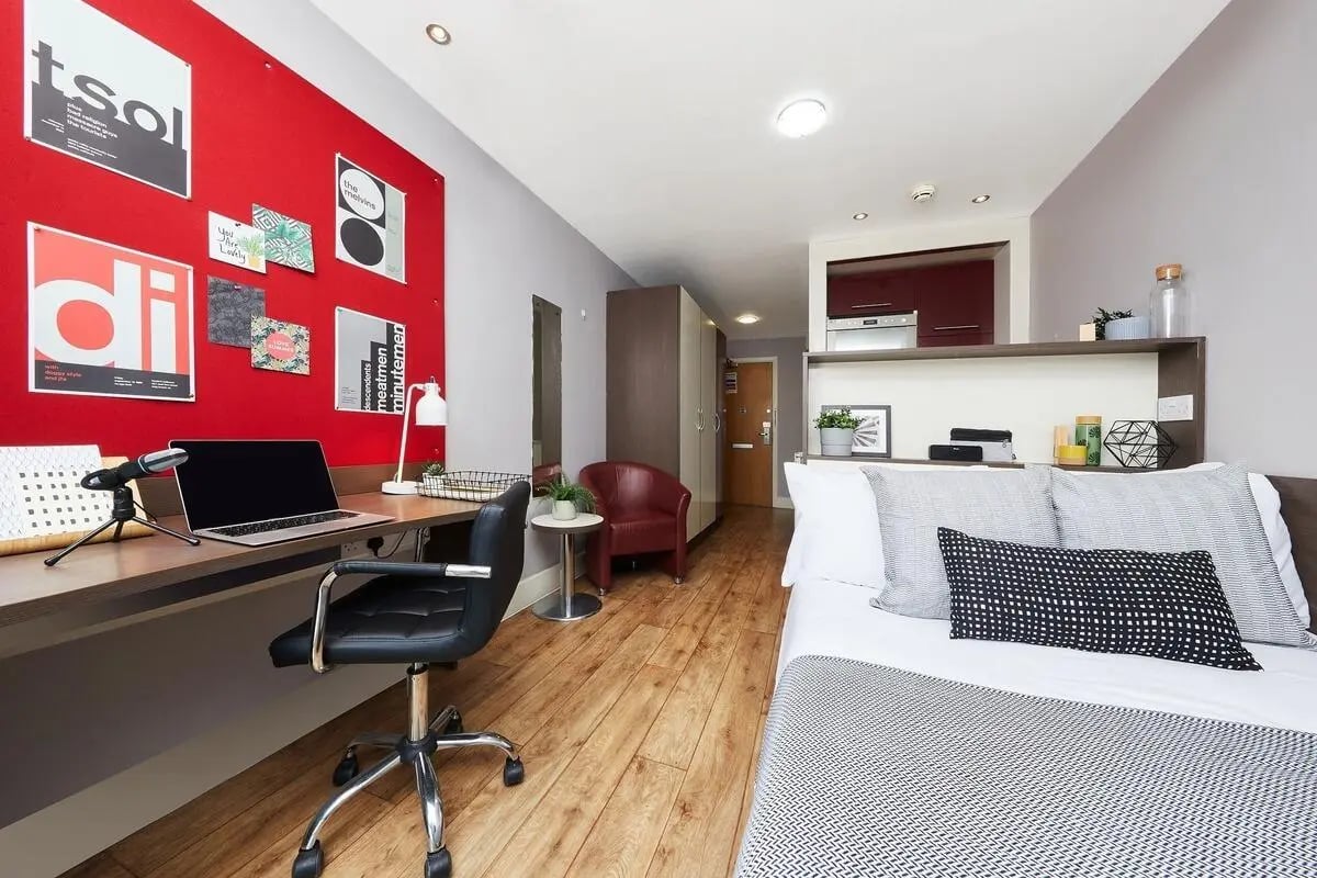 Desk chair laptop red wall bed study area at Collegiate Dashwood Studios in London Student Accommodation
