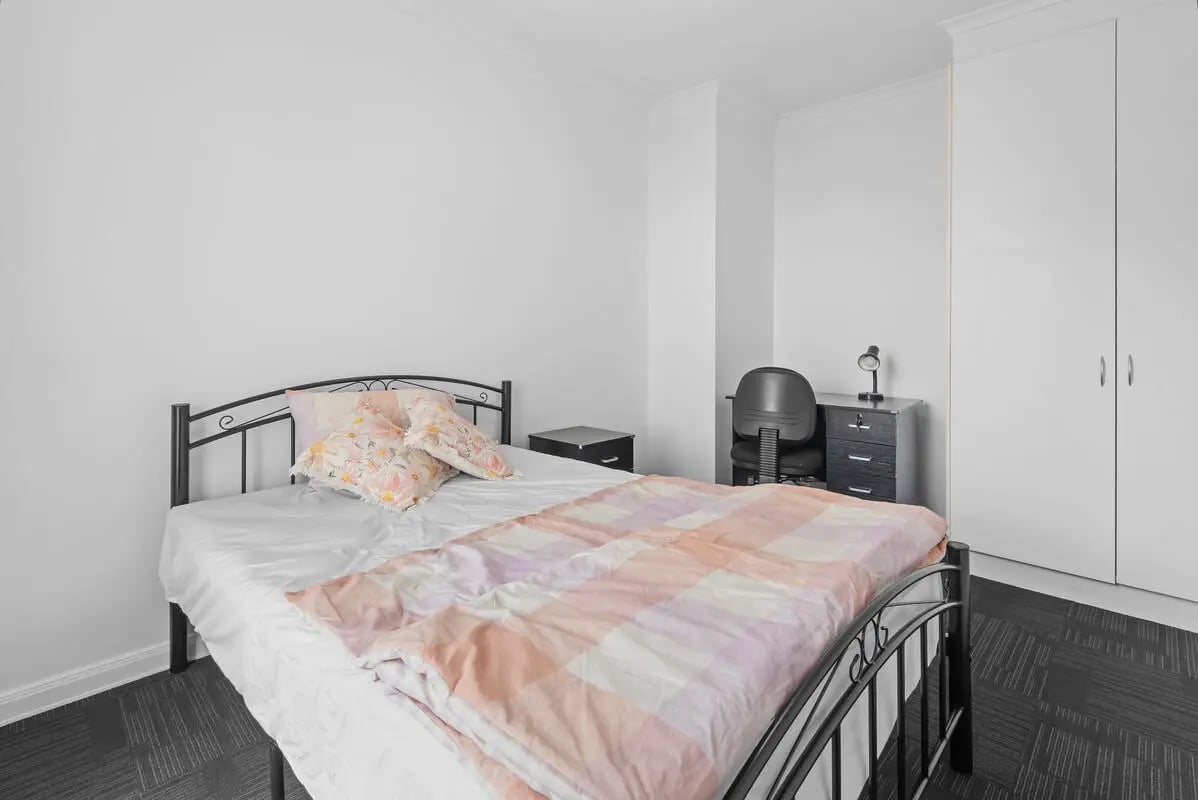 Bed desk chair and wardrobe bedroom at Student Living on Flinders in Melbourne Student Accommodation