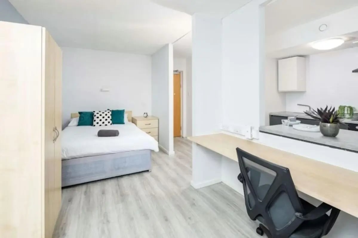 Bed closet desk and kitchen area studio at Capital Gate in Liverpool Student Accommodation