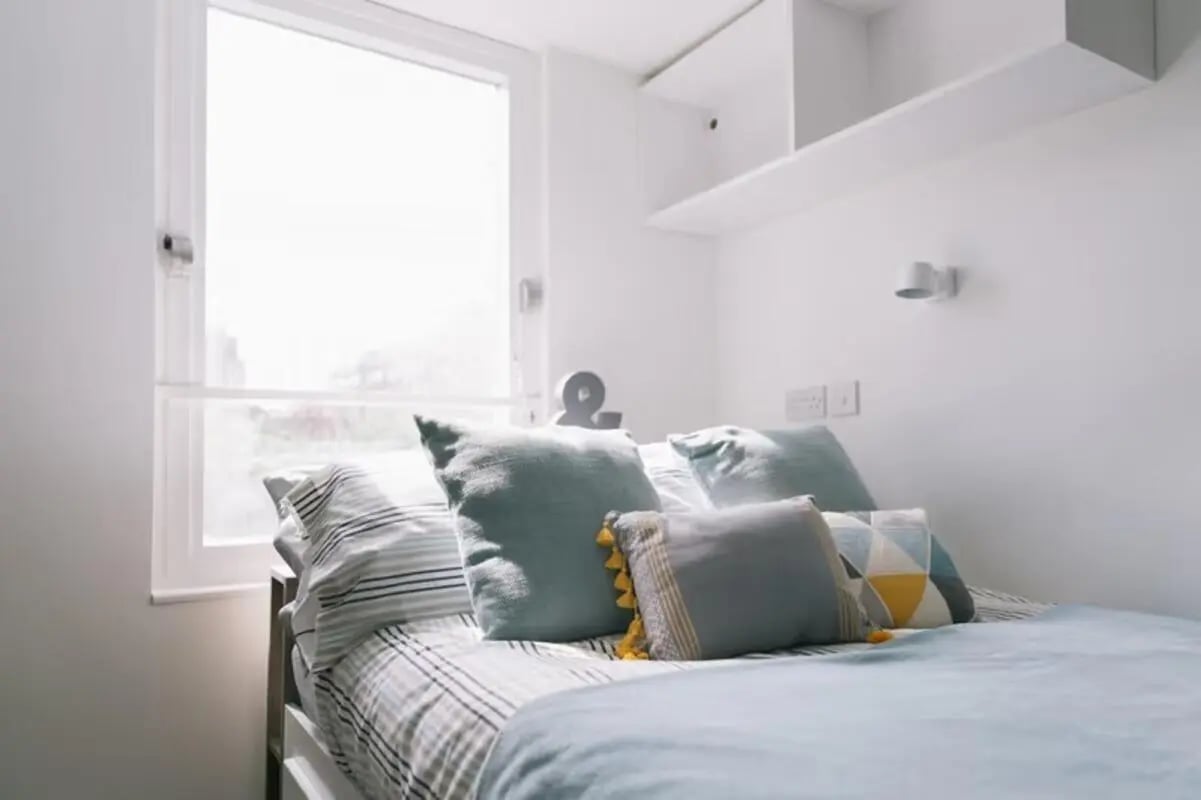 Bed with pillows window and shelf Bedroom at Claremont Place in Newcastle Upon Tyne Student Accommodation
