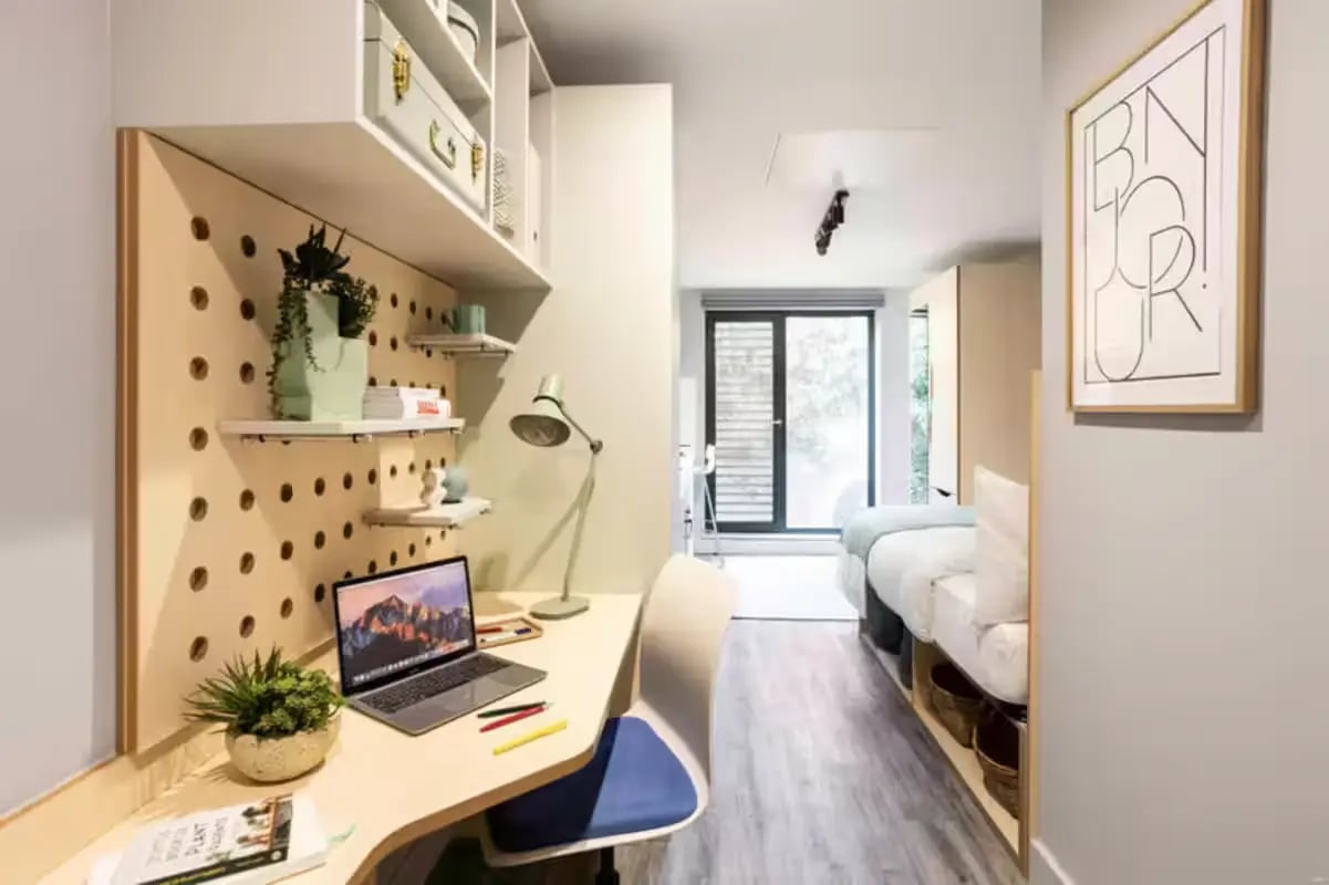 Desk with laptop bed and storage bedroom at Aster House in Belfast Student Accommodation