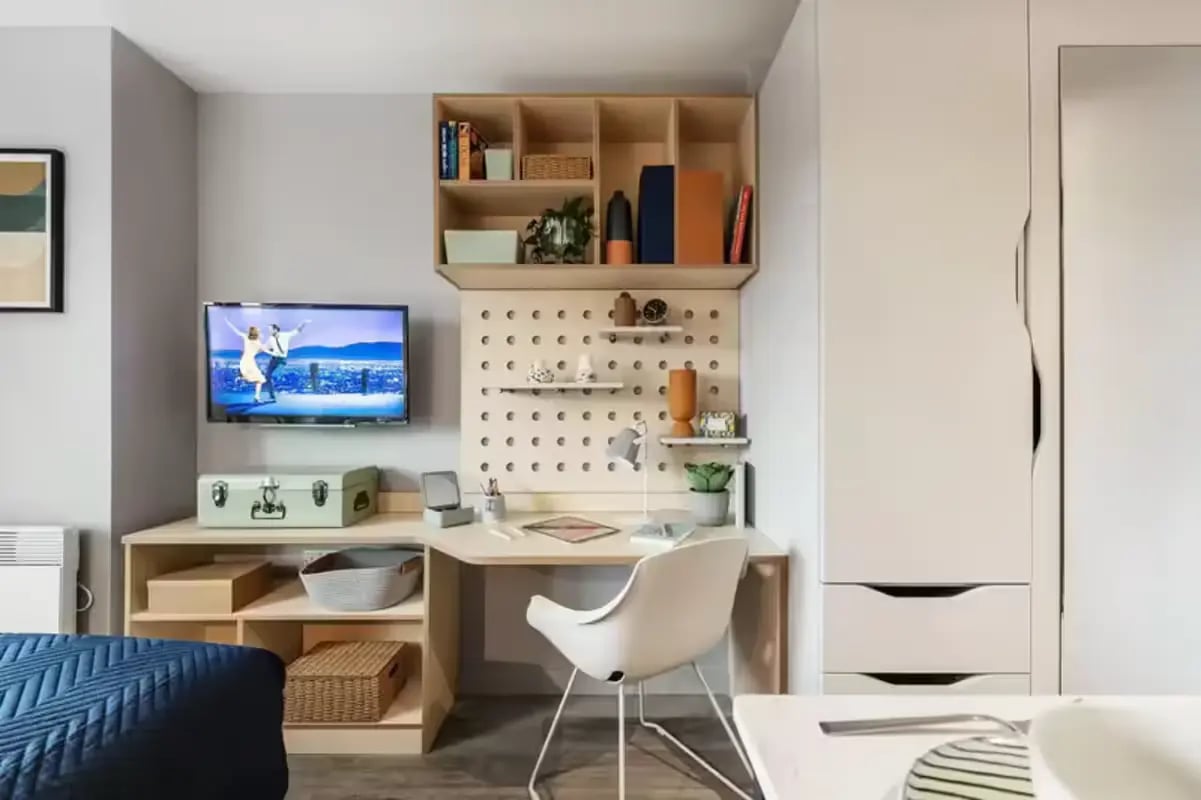 Desk with chair television and shelves study area at Huxley Studios in Edinburgh Student Accommodation