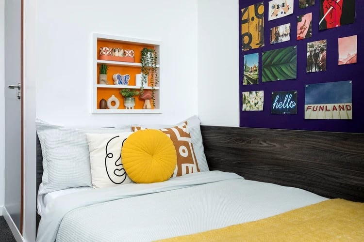 Bed with colorful pillows and wall art bedroom at Orion Point in Southampton Student Accommodation