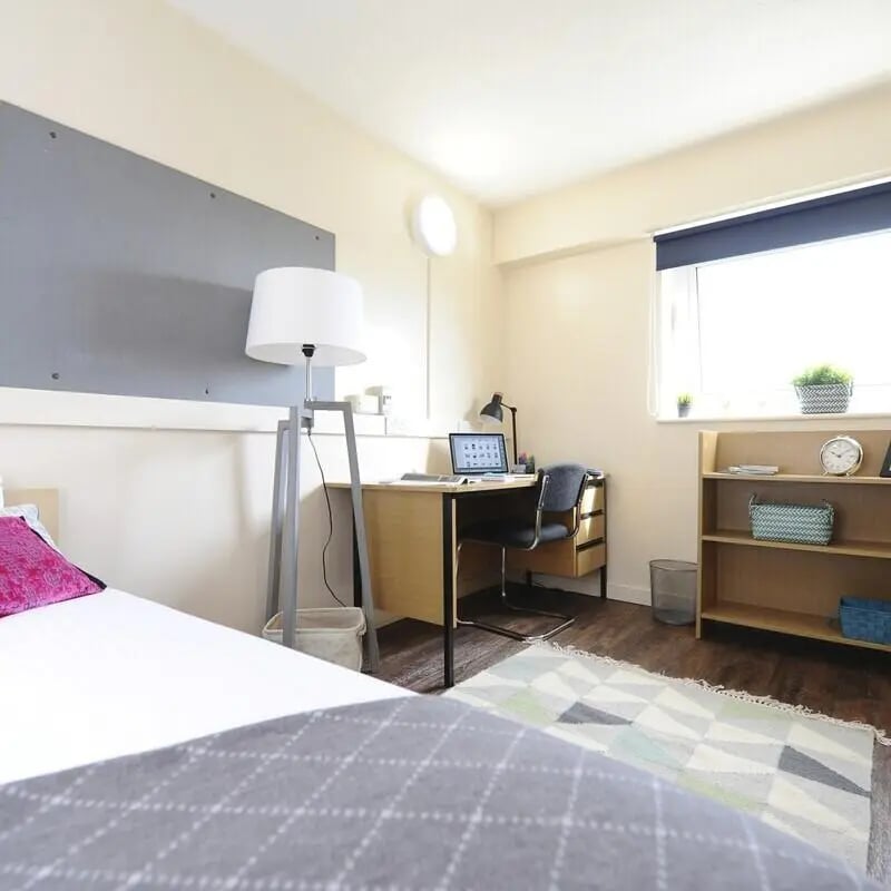 Bed desk lamp laptop chair bookshelf bedroom at John Lester and Eddie Colman Courts in Salford Student Accommodation