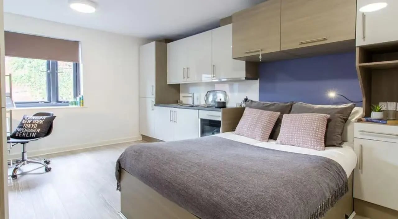 Bed with kitchen area study desk Bedroom Studio at St Giles Studios in Durham Student Accommodation