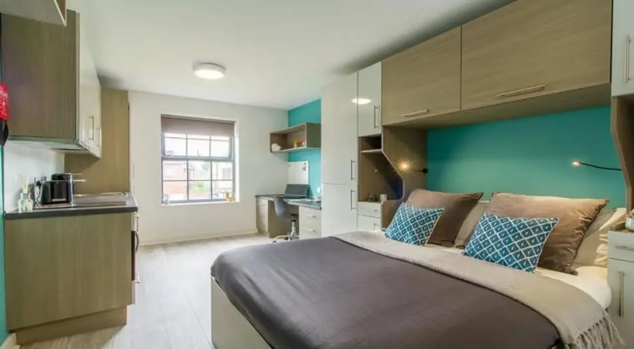 Bed study area kitchenette student studio bedroom at St Giles Studios in Durham Student Accommodation
