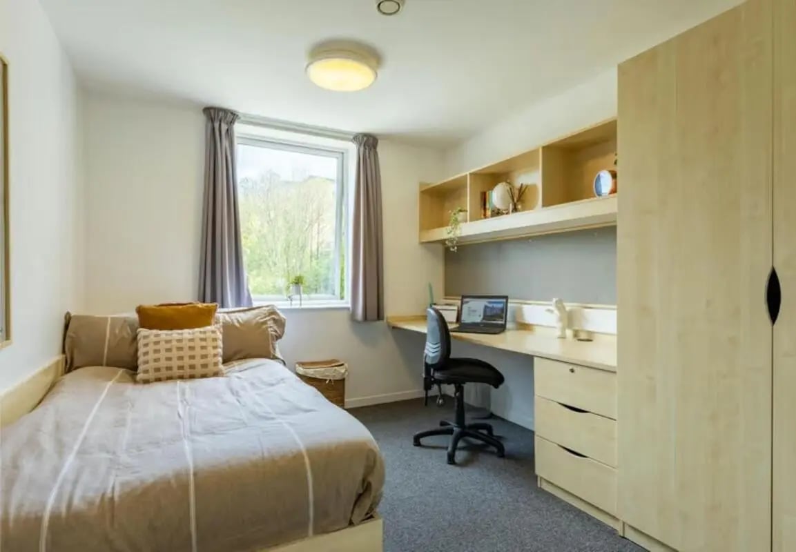 Bed desk chair shelves wardrobe bedroom at The Green in Bradford Student Accommodation