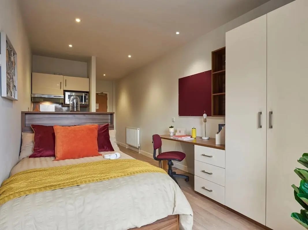 Bed desk wardrobe with kitchen area bedroom at Central Studios Reading in Reading Student Accommodation