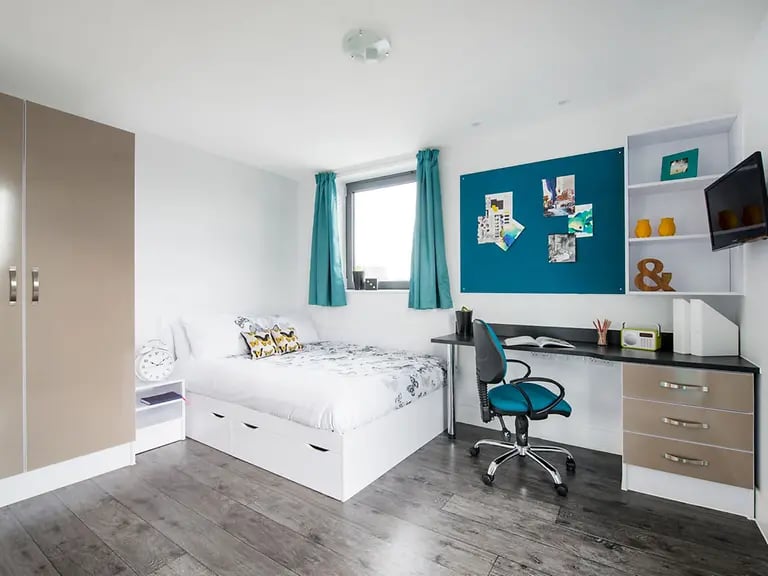 Bed desk chair corkboard and wardrobe bedroom at Yugo Canal Point in Edinburgh Student Accommodation