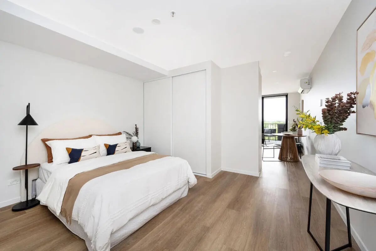 Bed with side table and lamp bedroom at Dickson Village Apartments in Canberra Student Accommodation