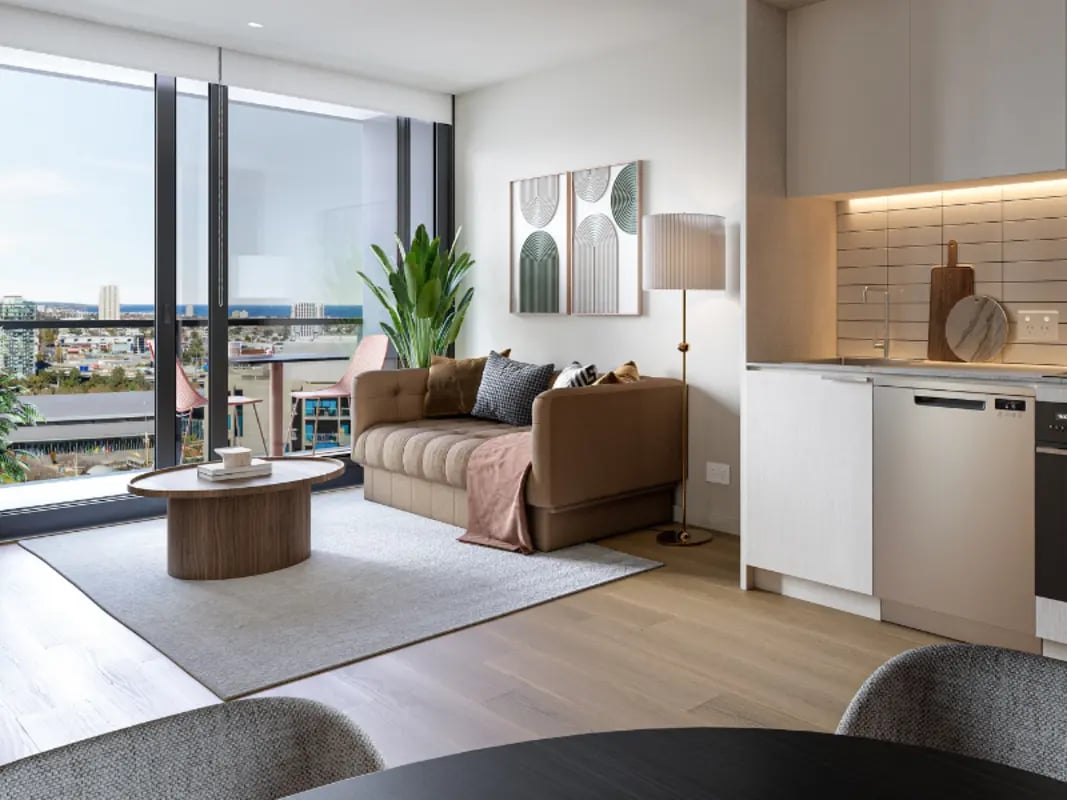 Sofa coffee table rug kitchen living area at West Tower, Melbourne Quarter in Melbourne Student Accommodation
