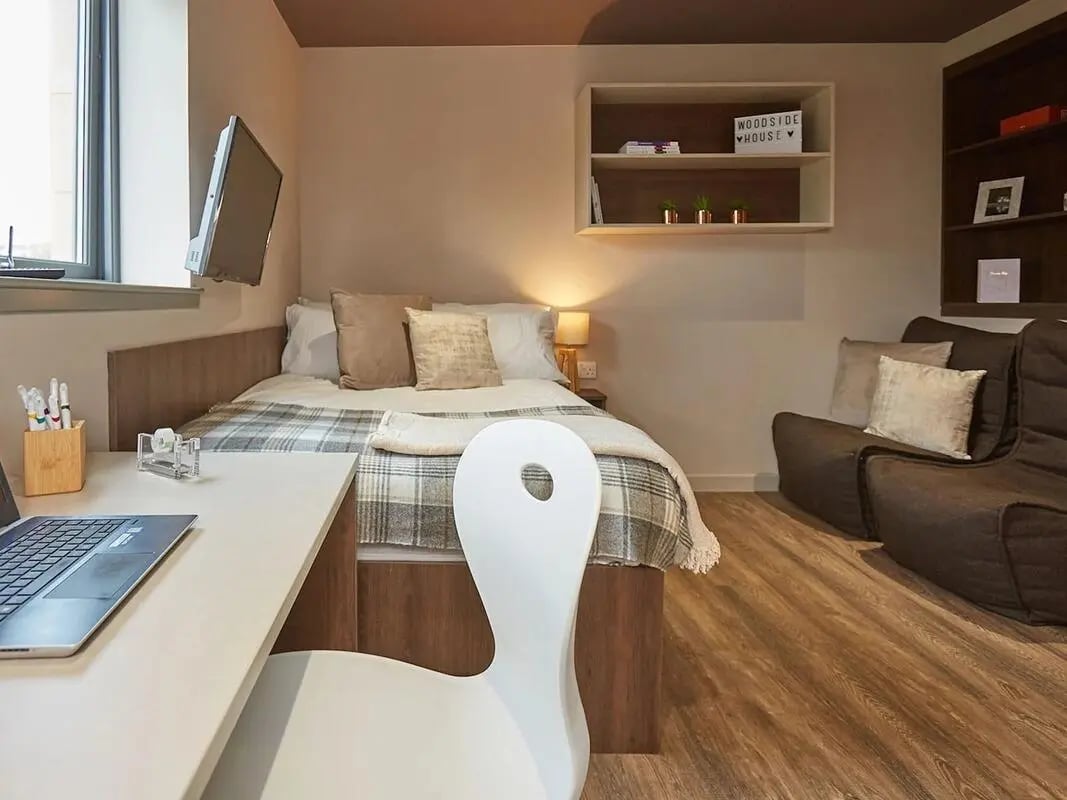 Bed desk chair and sofa bedroom at Woodside House in Glasgow Student Accommodation