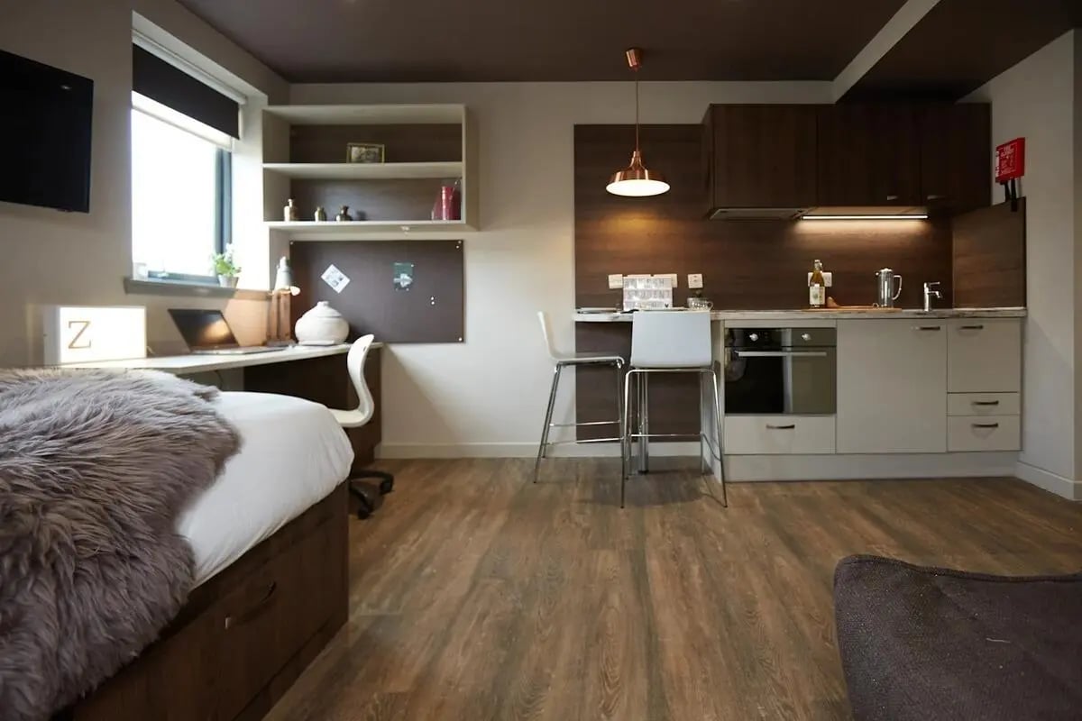 Bed desk kitchen and bar stools studio apartment at Woodside House in Glasgow Student Accommodation