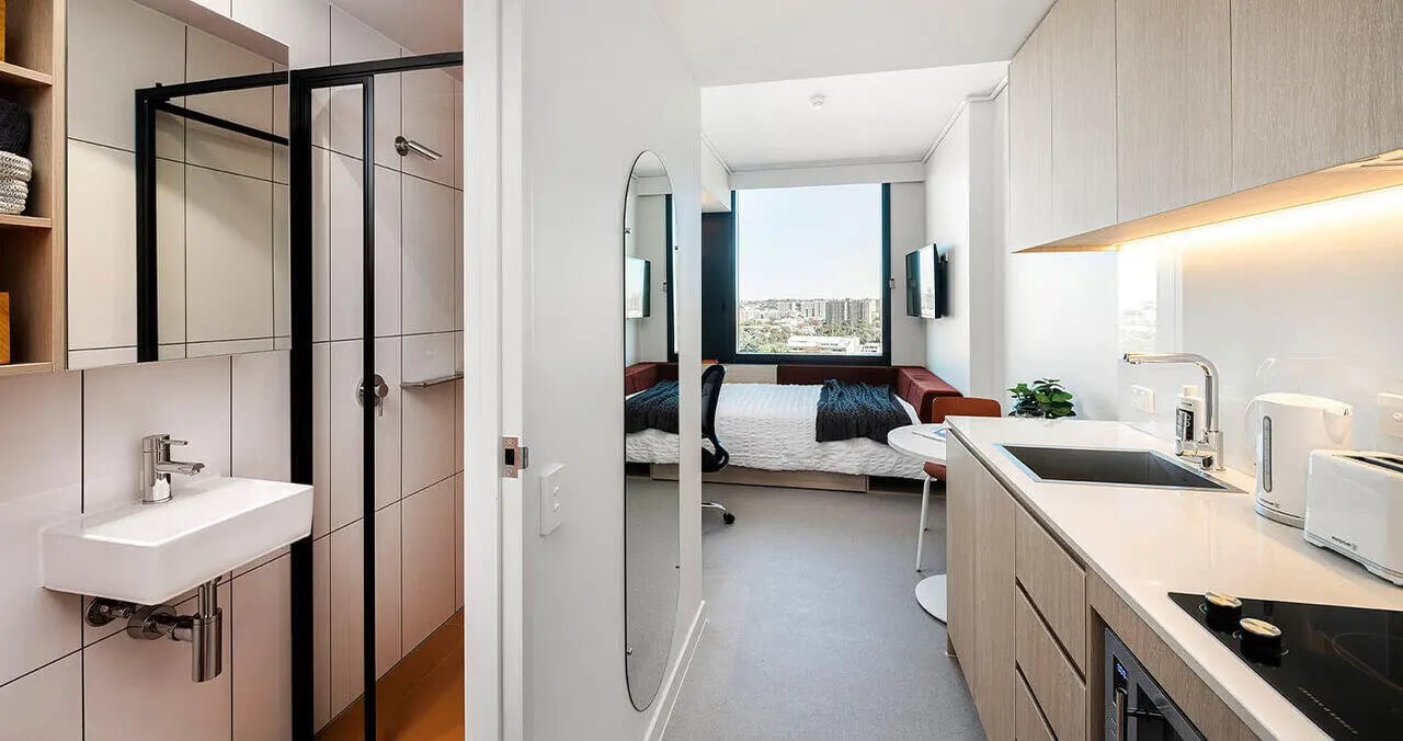 Sink shower and bed in studio apartment at Iglu Waterloo in Sydney Student Accommodation