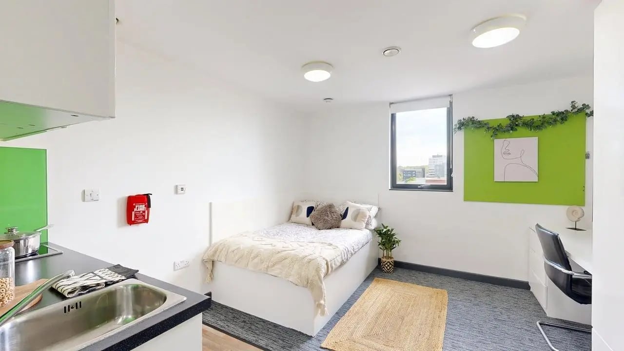 Bed desk sink and kitchen area studio apartment at Glassworks - Liverpool in Liverpool Student Accommodation
