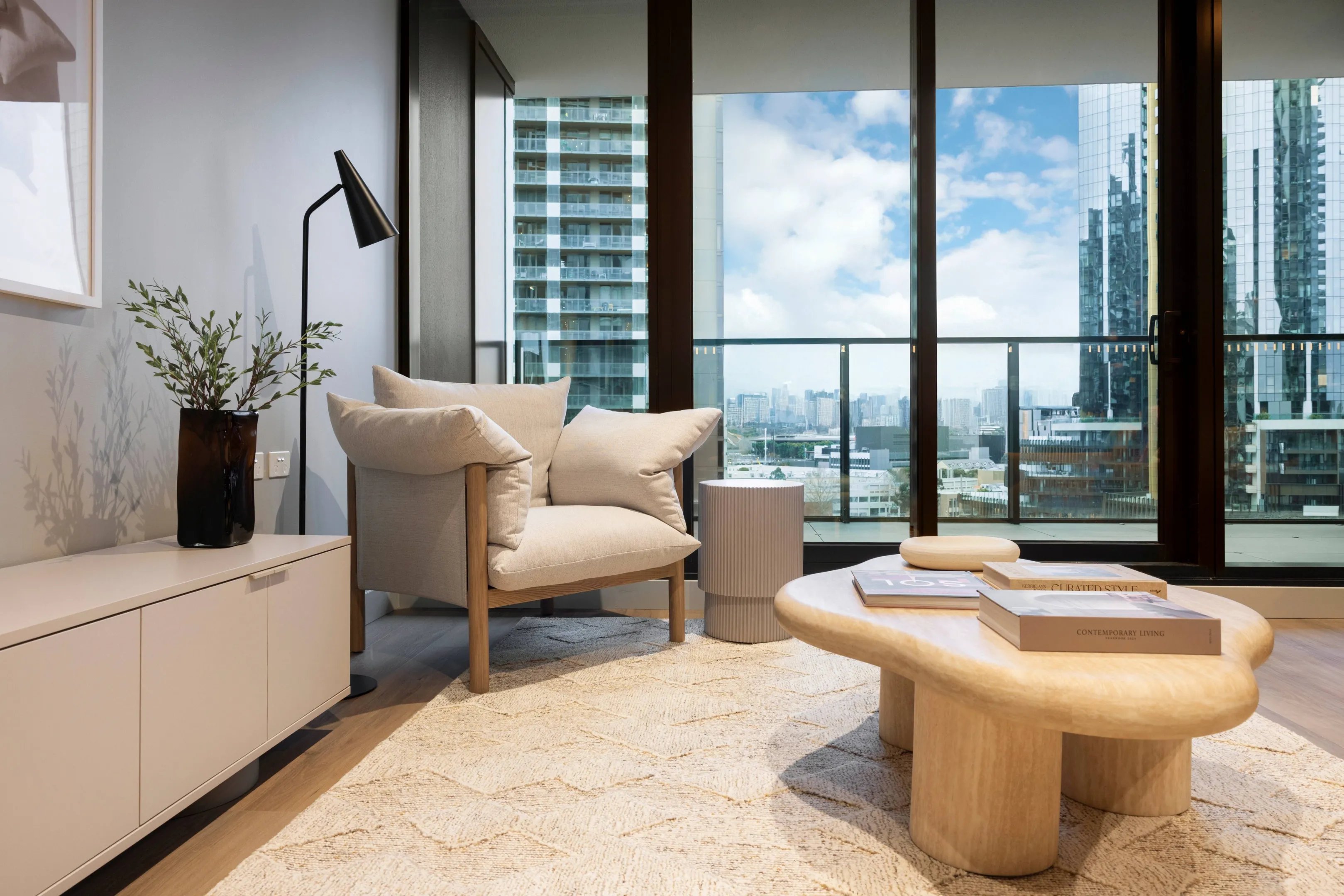 Armchair cabinet side table coffee table rug living room at Indi South Bank in Melbourne Student Accommodation