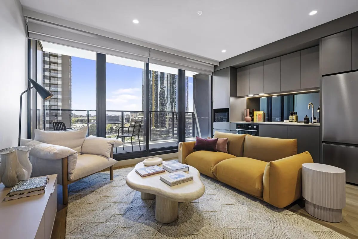 Yellow sofa armchair coffee table living room at Indi South Bank in Melbourne Student Accommodation