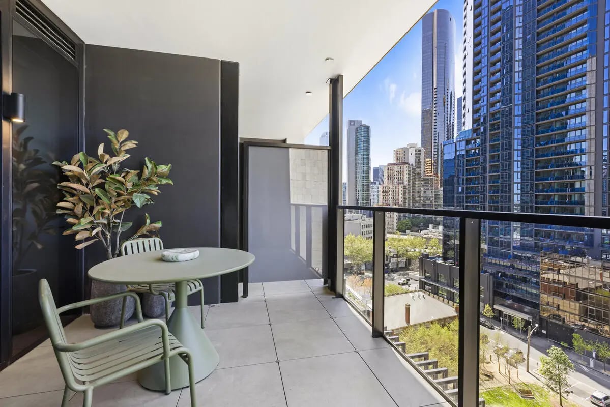 Balcony with table chairs and city view balcony at Indi South Bank in Melbourne Student Accommodation