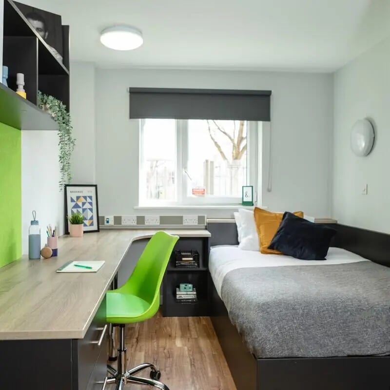 Bed desk shelves window and chair bedroom at Belgrave View in Birmingham Student Accommodation