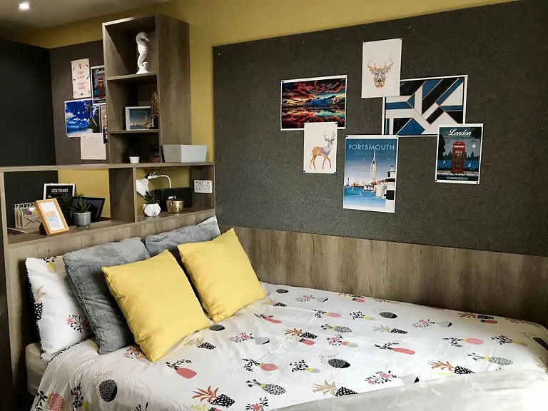 Bed with yellow grey pillows and pineapple duvet Bedroom at Yugo Catherine House in Portsmouth Student Accommodation
