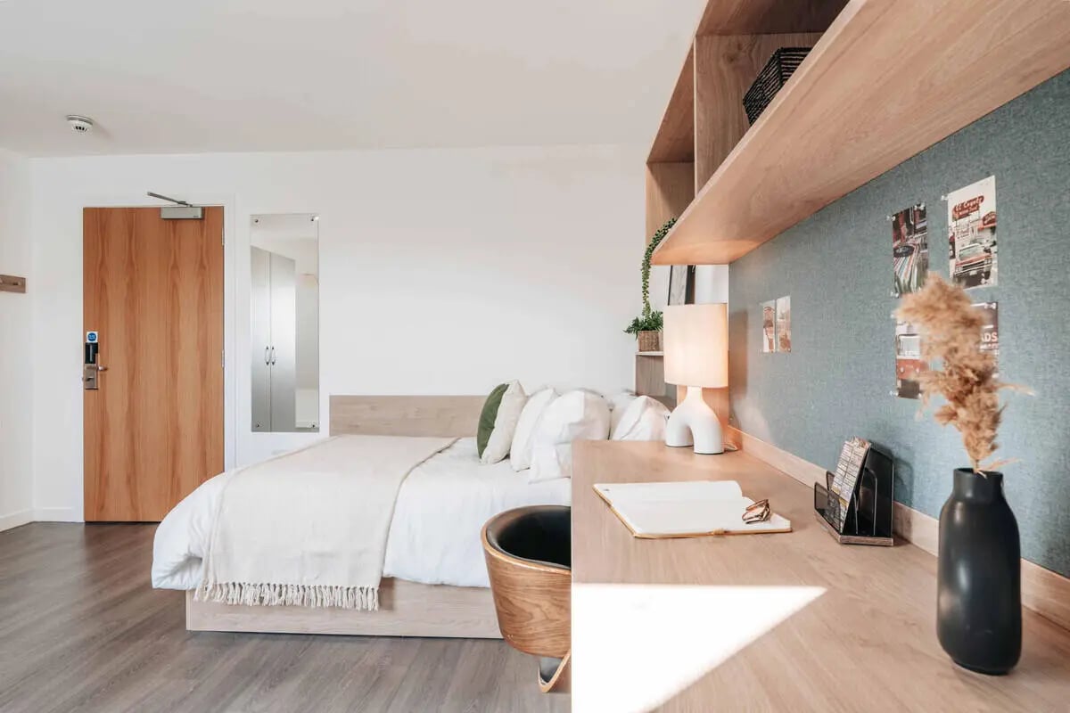 Bed with white bedding lamp and desk Bedroom at Caledon Court in Aberdeen Student Accommodation