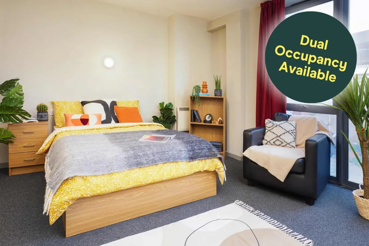 Bed armchair shelving unit rug bedroom at Jennens Court in Birmingham Student Accommodation