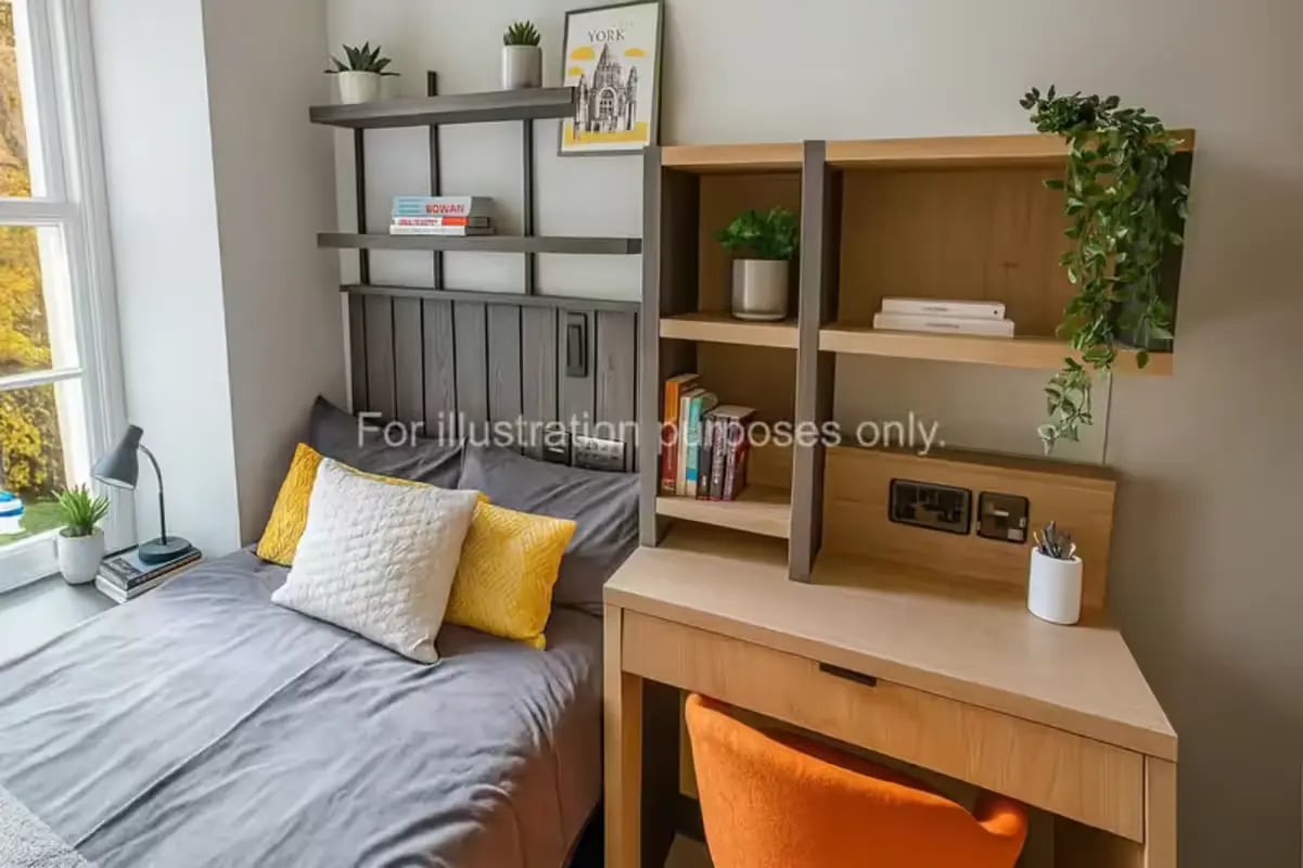 Bed desk shelves plant and lamp bedroom at The Port On The Square in Bristol Student Accommodation
