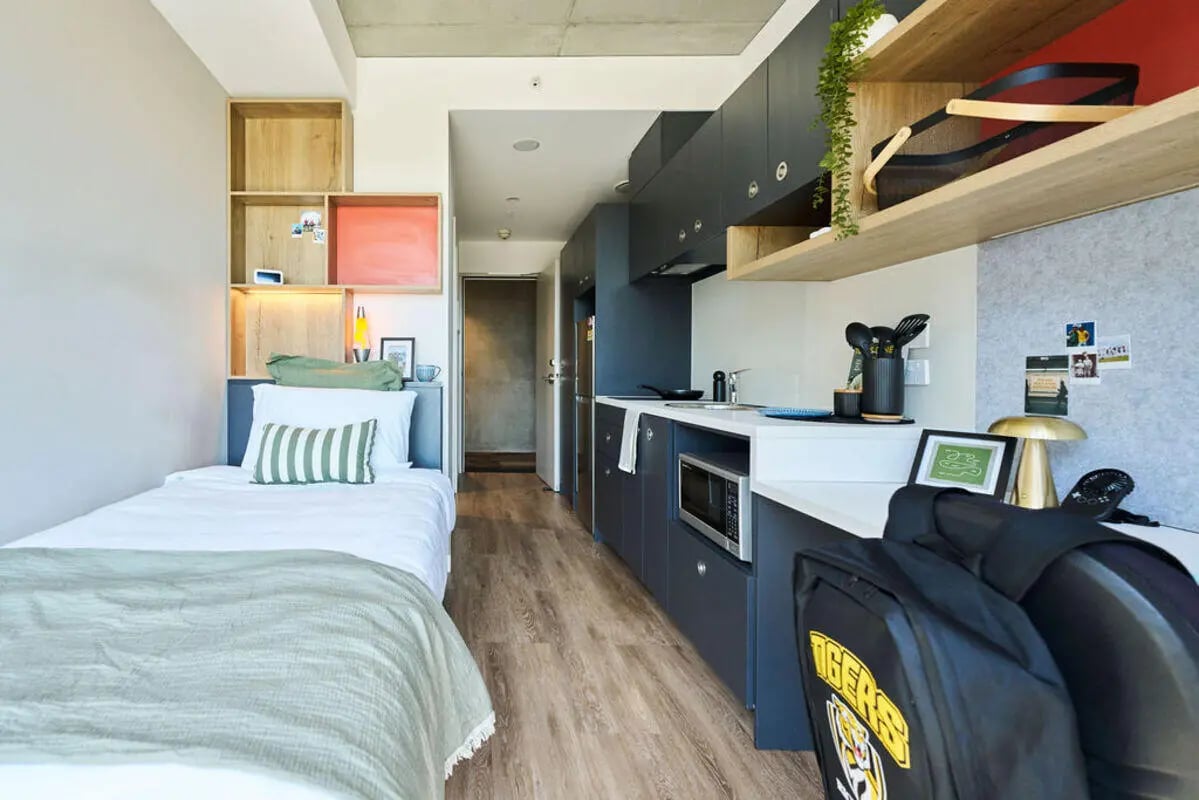 Bed kitchen and desk area student accommodation at UniLodge Royal Melbourne in Melbourne Student Accommodation