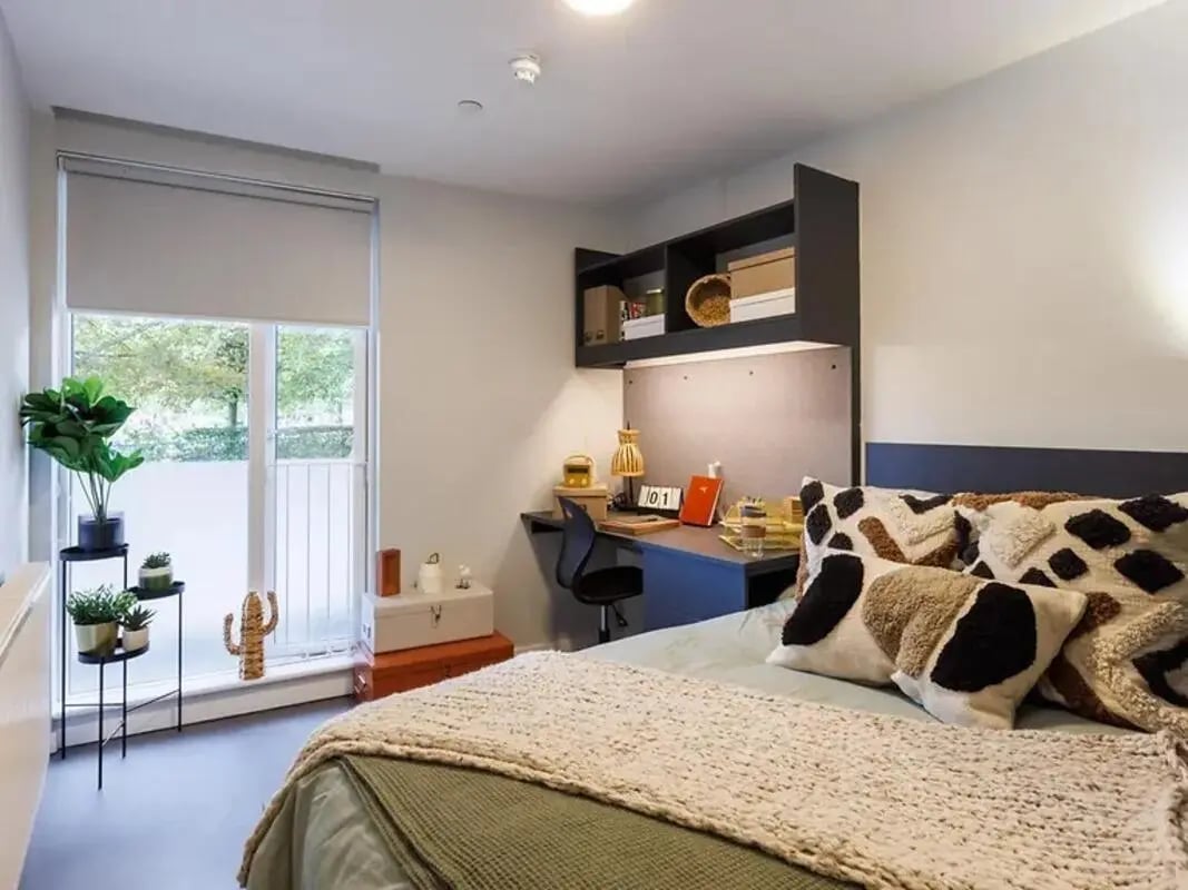 Bed desk plants and pillows bedroom at Element Bermondsey in London Student Accommodation