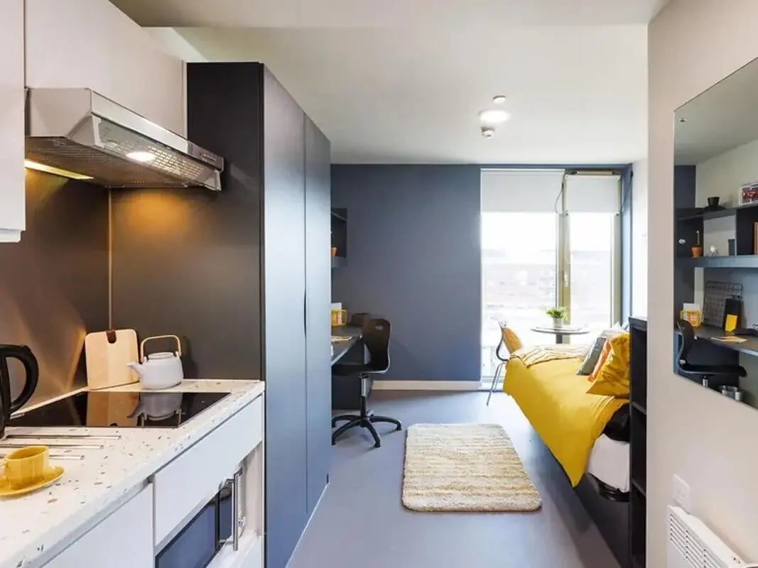 Kitchenette bed study desk and rug studio at Element Manchester in Manchester Student Accommodation