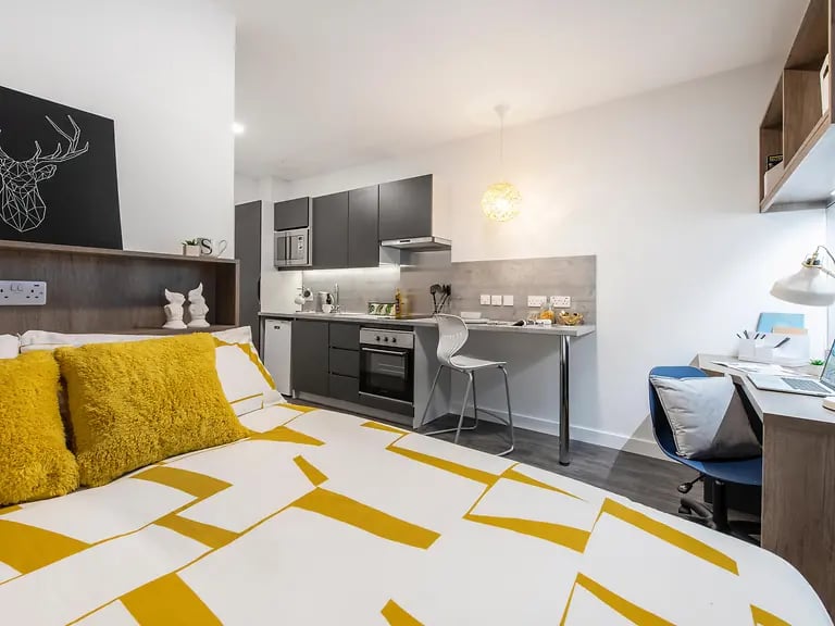 Bed kitchenette study area desk and chair at Yugo Bailey Point in Bournemouth Student Accommodation