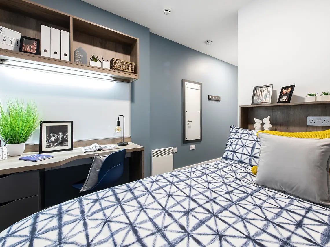 Desk plant lamp bed and shelving bedroom at Yugo Bailey Point in Bournemouth Student Accommodation