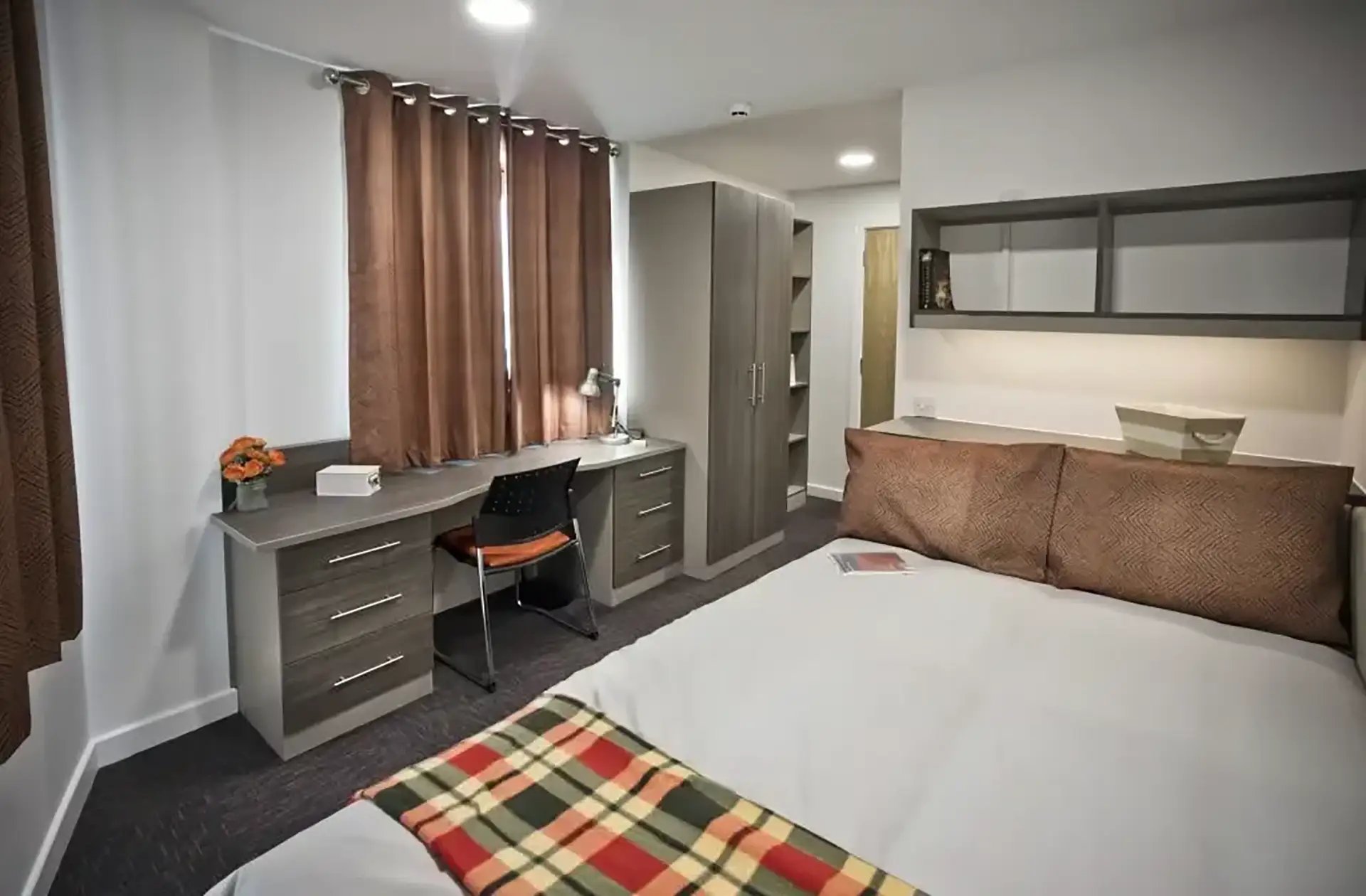 Bed desk wardrobe and shelves bedroom at Friargate Court in Preston Student Accommodation