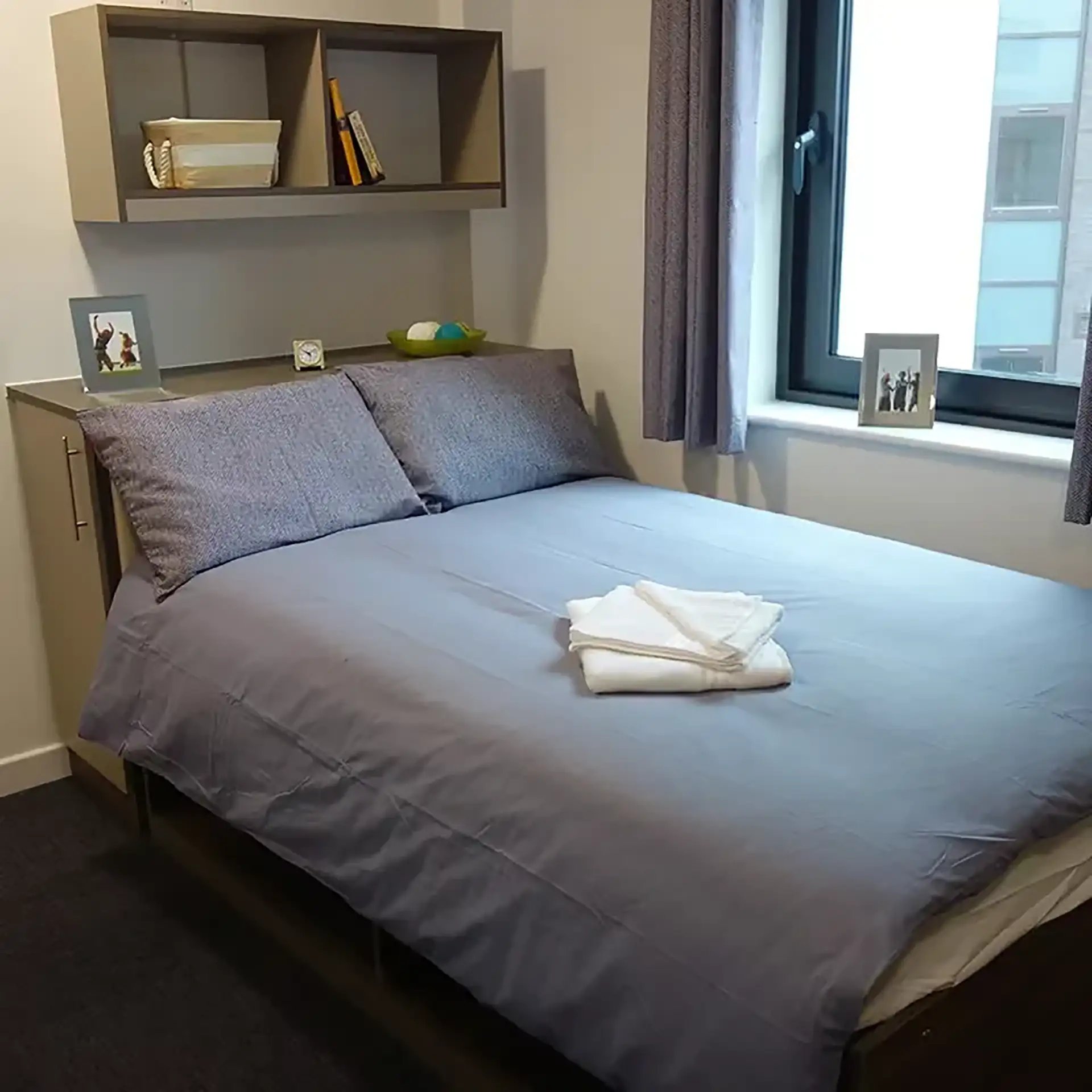 Bed with pillows and folded towels bedroom at Friargate Court in Preston Student Accommodation