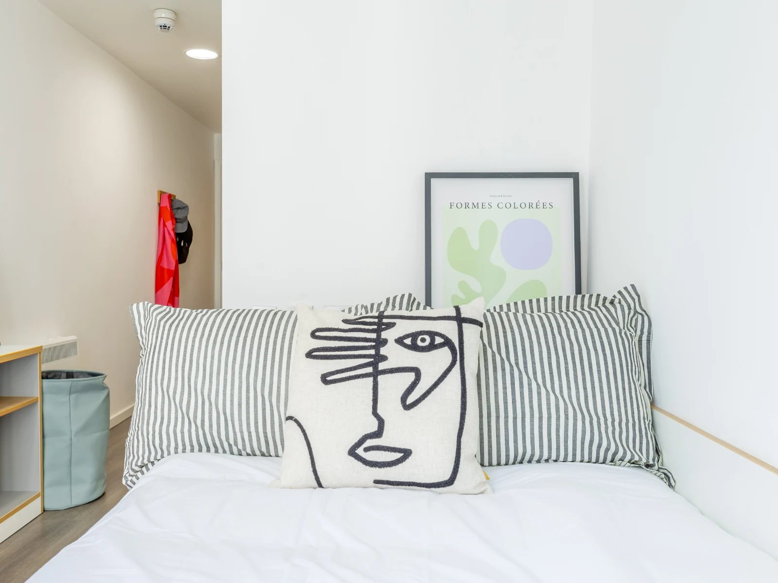 Bed with striped pillows abstract art bedroom at Dunaskin Mill in Glasgow Student Accommodation