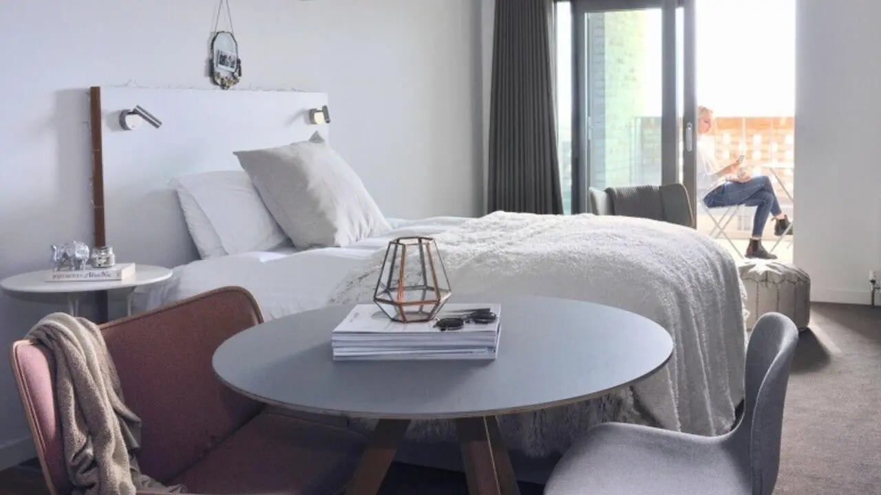 Bed side table and balcony bedroom at Victoria Hall Kings Cross in London Student Accommodation