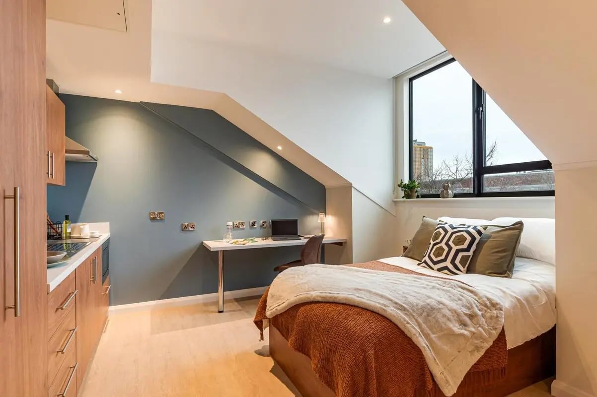 Bed desk kitchen and window Bedroom at Ryan Hall in Belfast Student Accommodation