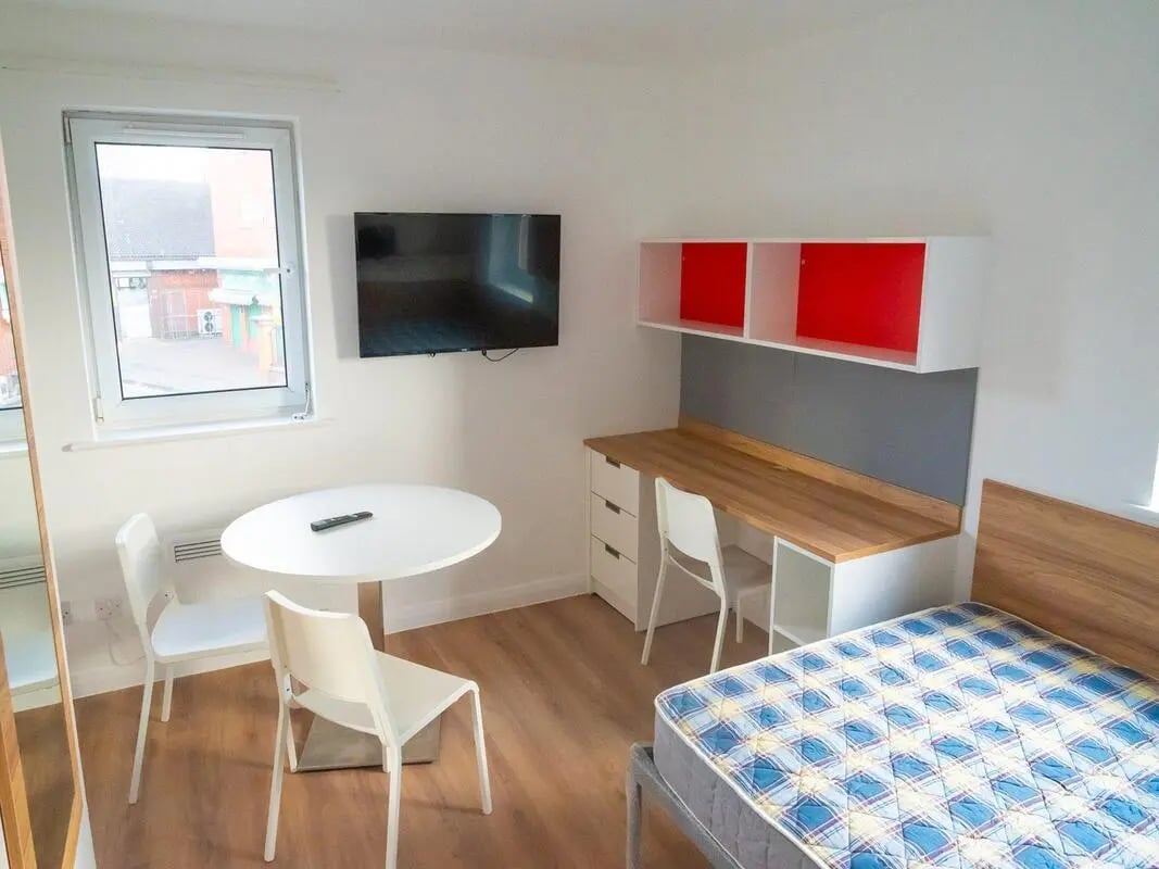 Bed desk TV round table and chairs bedroom at MSV South in Manchester Student Accommodation