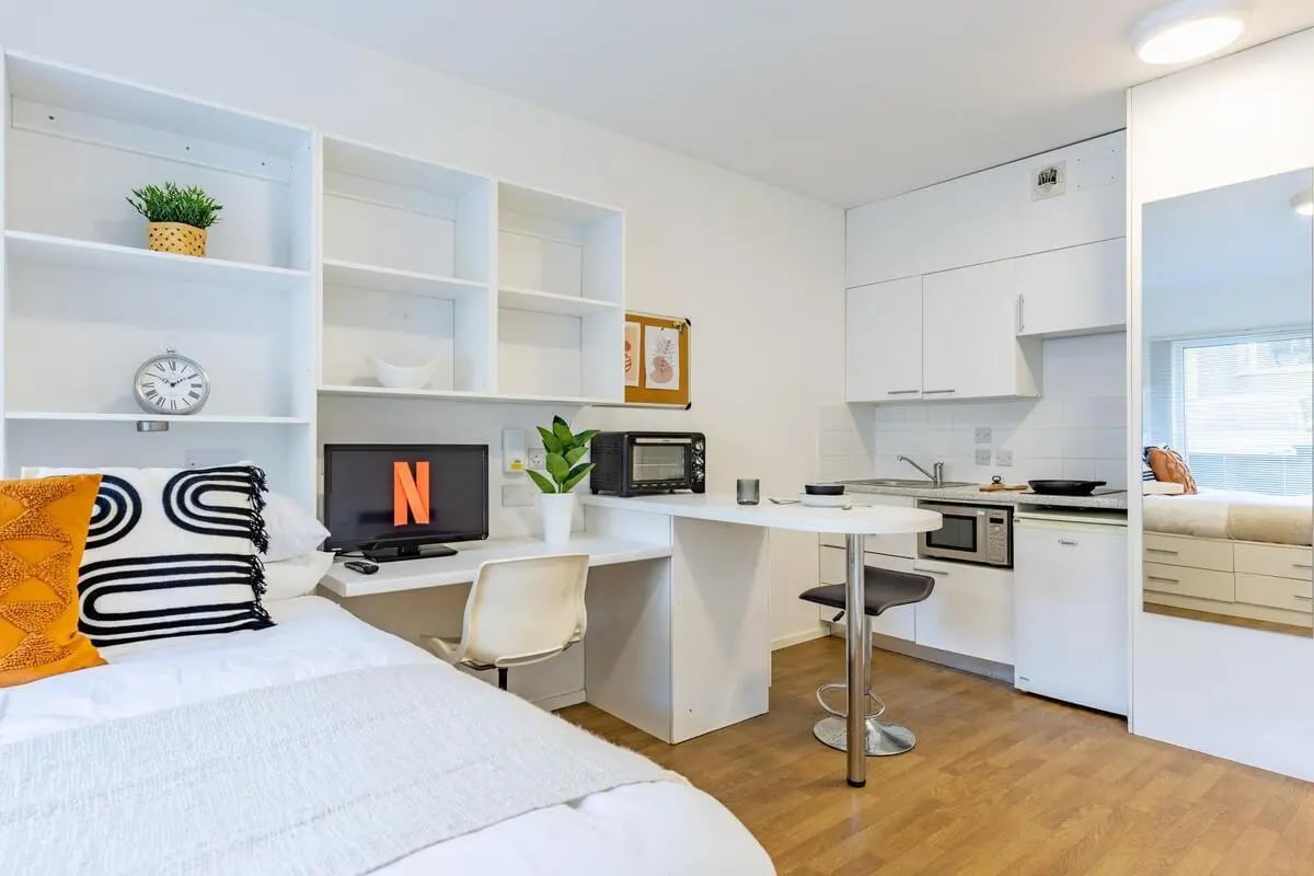 Bed desk kitchen and breakfast bar studio apartment at St Augustine's House in Plymouth Student Accommodation