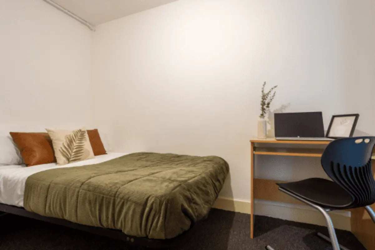Bed desk laptop chair and artwork bedroom at The Grafton in Manchester Student Accommodation