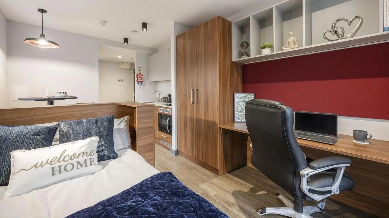 Bed desk chair laptop kitchenette and storage studio at Straits Garden in Egham Student Accommodation