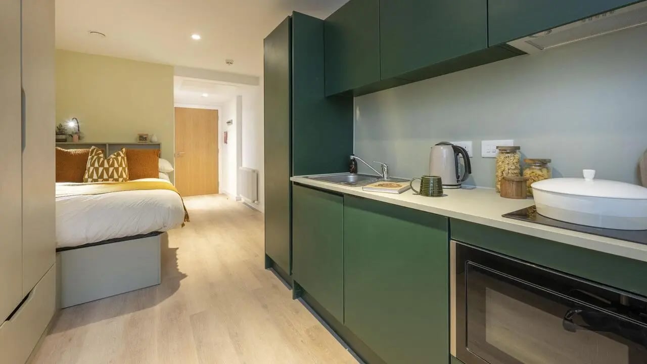 Bed kitchen with dark green cabinets and appliances at St Vincent Studios in Glasgow Student Accommodation